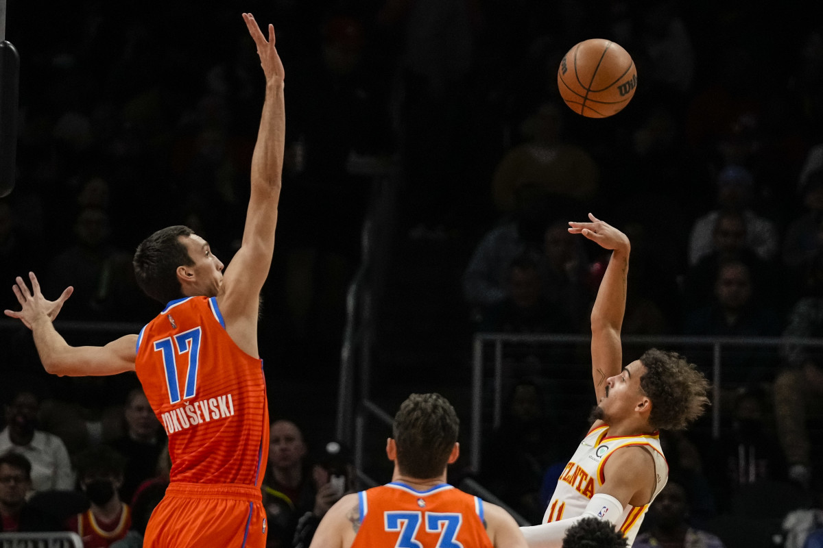 Atlanta Hawks guard Trae Young (11) shoots over Oklahoma City Thunder forward Aleksej Pokusevski (17) during the first half at State Farm Arena.